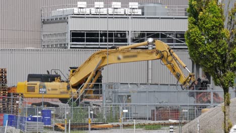 Komatsu-Excavator-With-Hydraulic-Claw-Clearing-Ground-At-Construction-Site-In-Switzerland