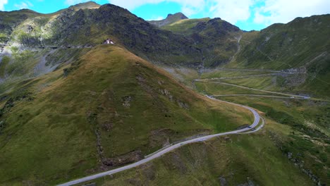 Switchbacks-wind-up-mountain-pass-Transfagarasan-Serpentine-Road-romania,-aerial-perspective