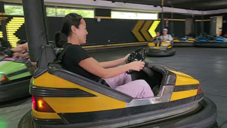 Family-Having-Fun-Driving-Bumper-Car-Attraction-in-Seoul-Land-Amusement-Park,-South-Korea