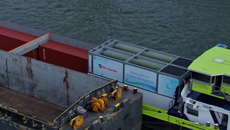 Dangerous-liquid-Hydrogen-being-transported-by-container-Barge,-aerial