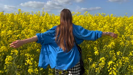 Young-woman-hugs-canola-yellow-flower-bloom-field