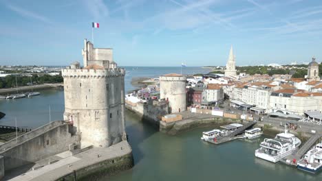 Tourist-old-port-of-La-Rochelle-with-Chain-and-Saint-Nicolas-towers,-France