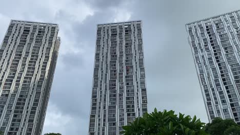 Low-angle-shot-of-residential-building-complex-with-three-towers-called-Urbana-Towers-in-Kolkata,-India-on-a-cloudy-day