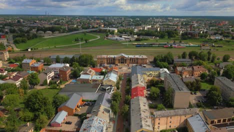 Panoramic-aerial-view-of-Daugavpils-Pass-train-station-building,-street,-neighborhood,-Housing-and-cityscape,-Latvia