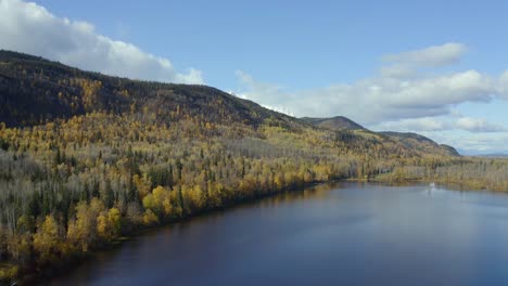 A-high-up-moving-aerial-drone-shot-of-Seymour-Lake-in-the-Smithers,-northern-British-Columbia-area-during-the-autumn-months