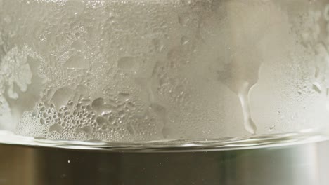 Macro-of-fogged-up-glass-filled-with-hot-water