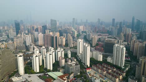 Aerial-establishing-shot-of-the-Putuo-Residential-district-with-the-Shanghai-skyline