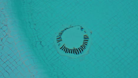Swimming-pool-drain-valve-at-the-bottom-of-the-swimming-pool-in-clear-water