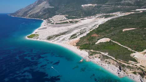 Ionian-Seaside-Paradise:-Beautiful-Blue-Turquoise-Sea,-Expansive-White-Beach,-Luxurious-Villages-on-Hilltops-Overlooking-the-Coastal-Beauty-in-Palasa,-Albania