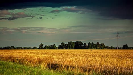 Stormy,-dark-clouds-gather-and-rain-over-a-farmland-field---dramatic-cloudscape-time-lapse