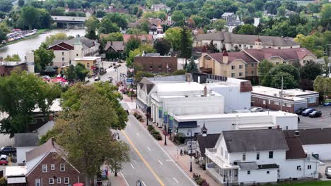 FRANKENMUTH,-MI---September-10,-2023---A-zoomed-slowly-moving-forward-aerial-establishing-shot-of-the-main-street-of-Frankenmuth-Michigan-during-the-Auto-Fest-of-2023