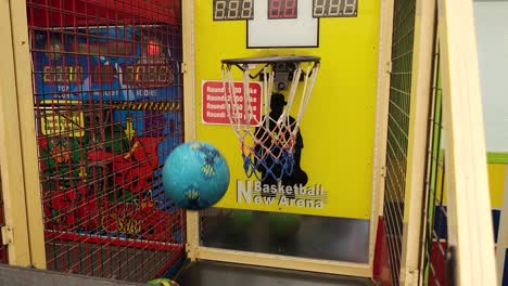 Colorful-Basketball-Balls-Thrown-into-Baskets-in-a-Vibrant-Park-Game,-Capturing-the-Joy-of-Skill-and-Aim,-Fun-at-the-Arcade