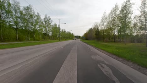 Travelling-at-high-speed-on-a-country-road-near-the-city-of-Porvoo,-Finland