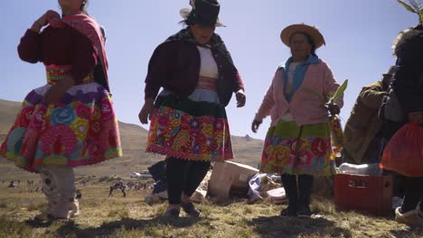 In-the-daytime,-women-dressed-in-traditional-attire-celebrate-the-Tayta-Shanti-festival-in-Huancayo,-Peru,-by-dancing-and-reveling-in-the-festivities