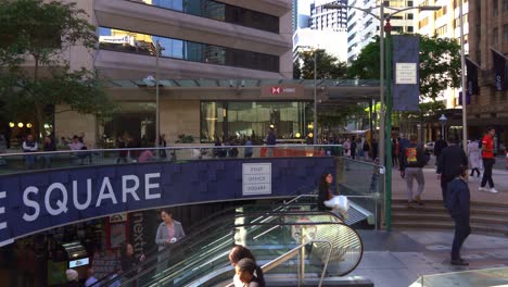 Large-crowd-of-office-workers-taking-the-escalator-down-to-the-food-court-at-post-office-square-at-busy-lunch-time-rush-hours,-Brisbane's-central-business-district,-building-before-facelift