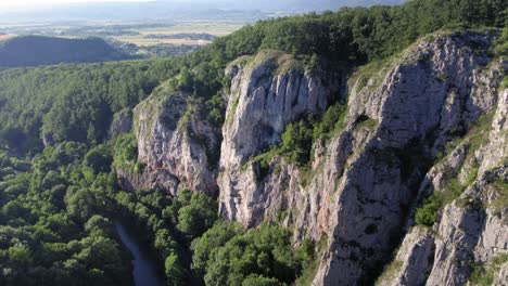 River-next-to-giant-limestone-rock-cliffs-with-a-harsh-sun