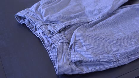 Footage-of-a-person-folding-a-pair-of-pants