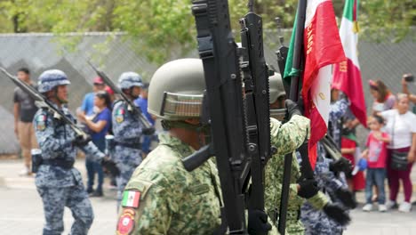 Armed-Forces-with-Mexican-Flag,-of-the-National-Army,-marching-through-Monterrey-Nuevo-León-in-the-commemorative-parade-of-the-Independence-of-Mexico