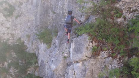 Closeup-of-tourist-climbing-a-via-ferrata-route-on-a-karst-mountain