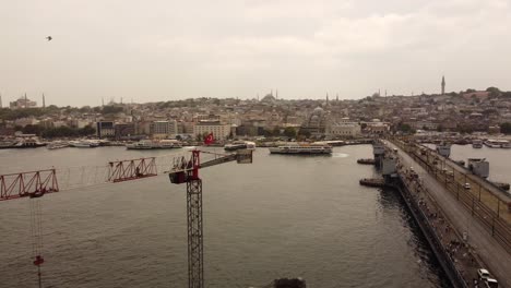 Aerial-drone-footage-of-galata-bridge-in-istanbul-with-a-turkish-flag
