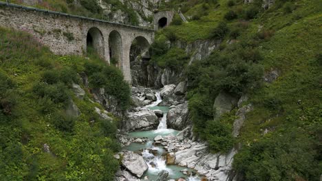 River-water-stream-under-bridge-in-summer-season-in-Furka-Pass-valley-of-Switzerland