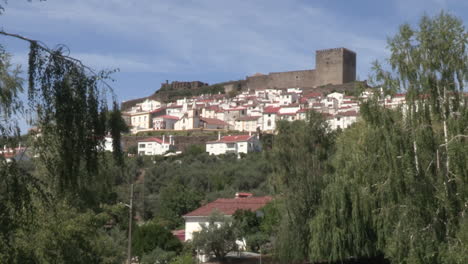 Castelo-de-Vide-in-the-background-on-the-hillside-around-it-small,-white-painted-houses,-Castelo-de-Vide-is-a-Portuguese-village-in-the-district-of-Portalegre