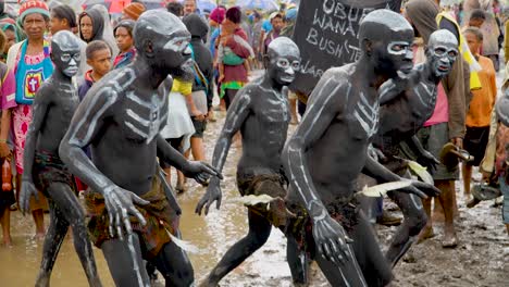 Frightening-Papua-New-Guinean-cultural-display,-black-body-paint-tribal-group