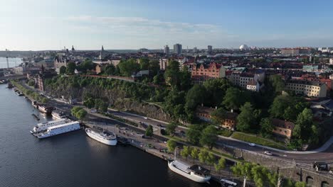 Aerial-view-of-river-shore-with-scenic-spot,-cityscape-of-Stockholm,-sunny-day-in-Sweden