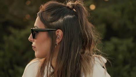 Medium-Close-Up-Shot-Of-Lady-Wearing-Sunglasses-Looking-Around