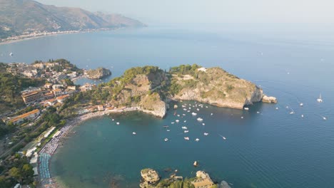 Incredible-Isola-Bella-Island-in-Sicily,-Italy---Backwards-Drone-Shot