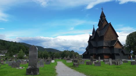 Heddal-Stave-Church-and-Grave-Headstones-in-Vestfold-og-Telemark,-Norway,-Scandinavia---Pan