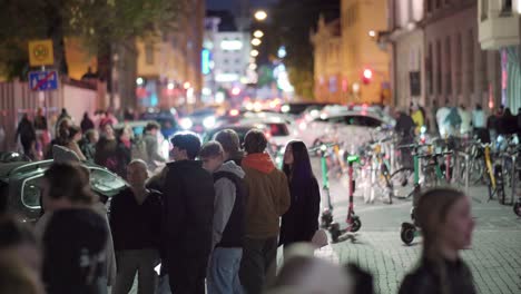 Group-of-teenagers-in-a-crowded-city-center-at-night