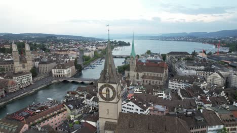 Orbital-View-over-Zurich-Downtown-with-Churches,-Bridges-and-Cathedral,-Switzerland