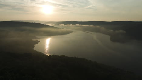 Slow-flyover-Lake-Fort-Smith-State-Park-misty-summer-sunrise,-Arkansas,-USA---Aerial