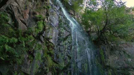 Cascade-of-Water-on-Aguacaida-Waterfall-Over-Mossy-Cliff-In-Panton,-Spain