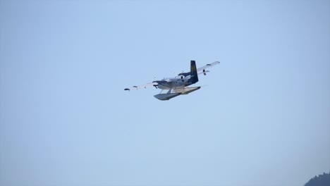 Slow-Motion-of-Twin-Engine-Turboprop-Seaplane-Flying-Against-Blue-Sky
