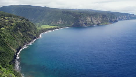 Spectacular-cliff-coastline-in-Waipio-Bay,-aerial-flying-above-ocean,-Hawaii