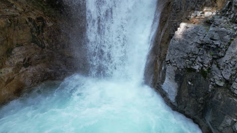 Rocky-Waterfall-Flows-into-Blue-Bubbling-Pool-of-Water