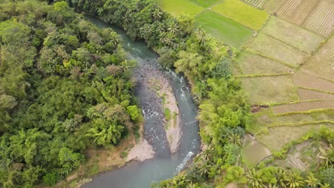 Birds-Eye-Drone-View-of-Natural-Winding-River-in-Tropical-Country-of-Indonesia