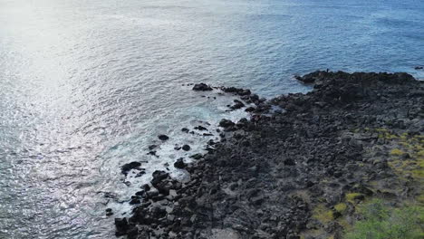 Rocky-volcanic-coastline-shore-in-Big-Island-Hawaii,-aerial-drone-rising-shot