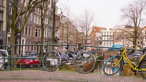 Bicycles-Parked-And-Locked-On-Canal-Bridge-In-Amsterdam,-Netherlands