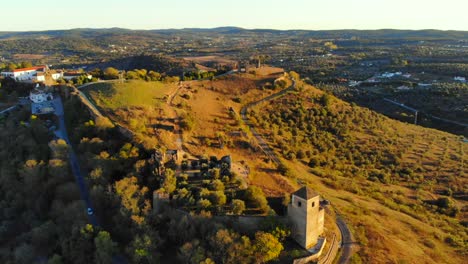 Drone-shot-of-a-medieval-tower-on-a-hill-in-Alenteo,-Portugal