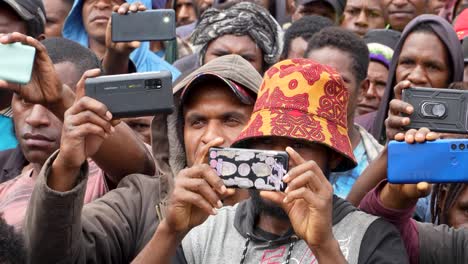 People-in-crowd-take-photos-with-cell-phones,-Papua-New-Guinea