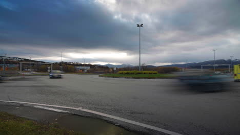 Long-exposure-timelapse-of-vehicle-traffic-flow-at-roundabout,-overcast-weather