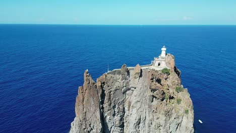 Lighthouse-ate-Strombolicchio-Volcano-Island-near-Stromboli-at-Aeolian-Islands,-Sicily,-Italy---Aerial-4k