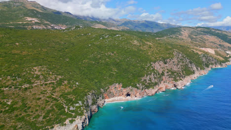 Aerial-drone-shot-flying-high-over-secluded-area-of-Gjipe-Beach-in-Dhermi,-Albania-on-a-sunny-day