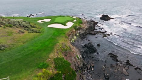 wide-orbiting-drone-shot-of-the-iconic-7th-hole-at-Pebble-Beach-Golf-Links-in-California