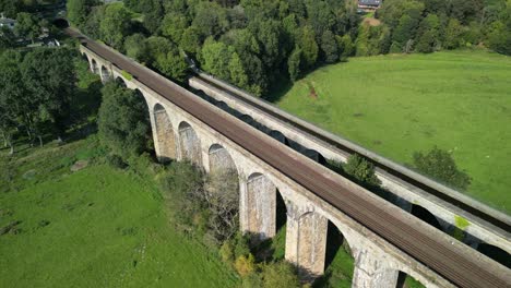 Fly-over-Chirk-railway-Viaduct,-revealing-Aqueduct-and-valley---aerial-drone-anti-clockwise-rotate---Welsh,-English-border,-Sept-23