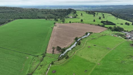 Aerial-flying-over-green-pastures-and-fertile-farmlands-in-waterford-Ireland