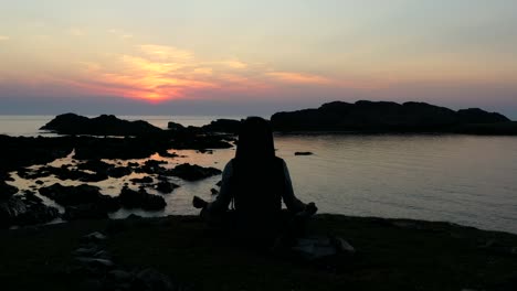 Magical-sunset,-silhouette-of-man-meditating